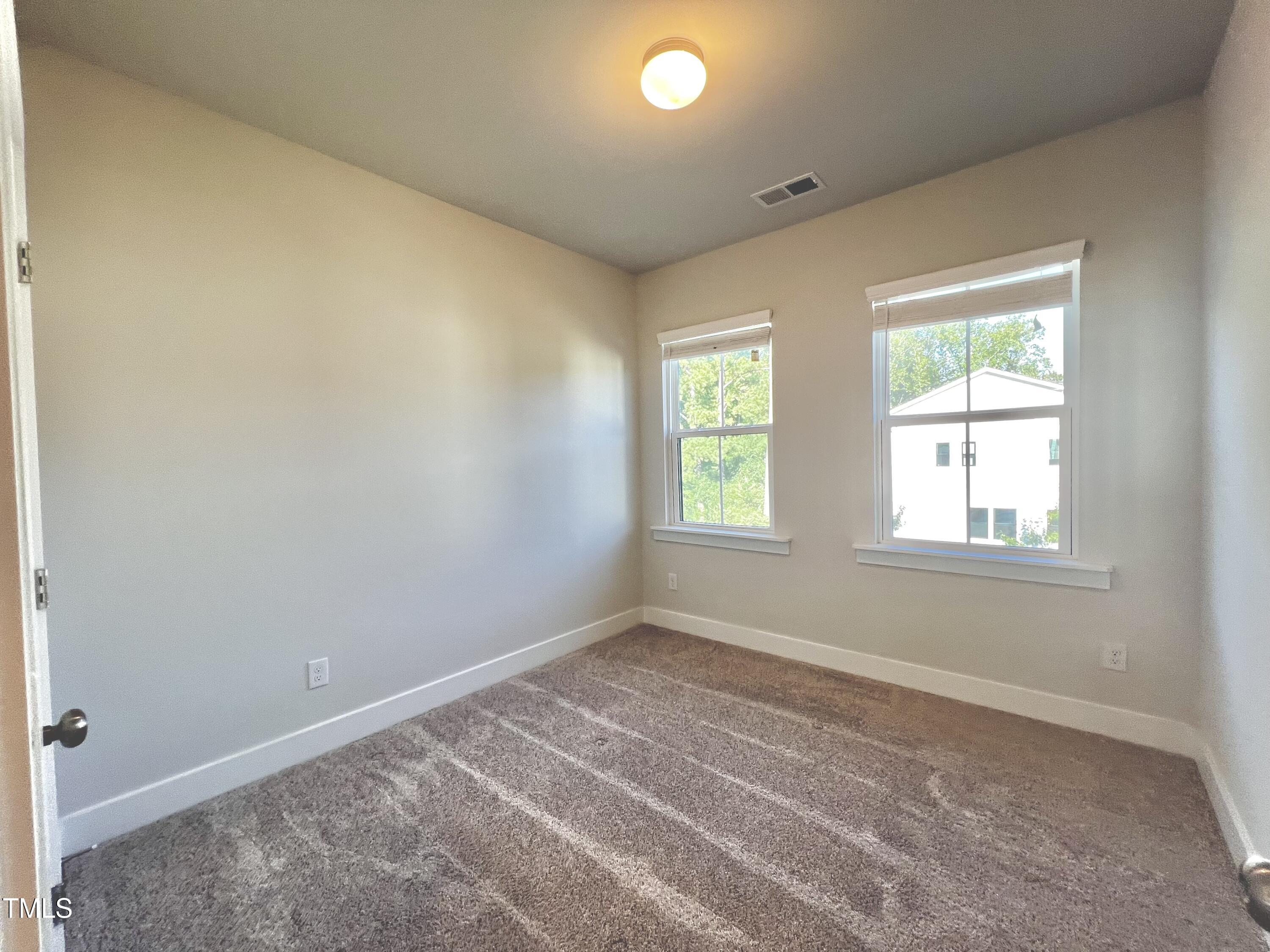 906 Waterside View Drive Raleigh, NC 27606 - Photo 27 of 27 an empty room with windows