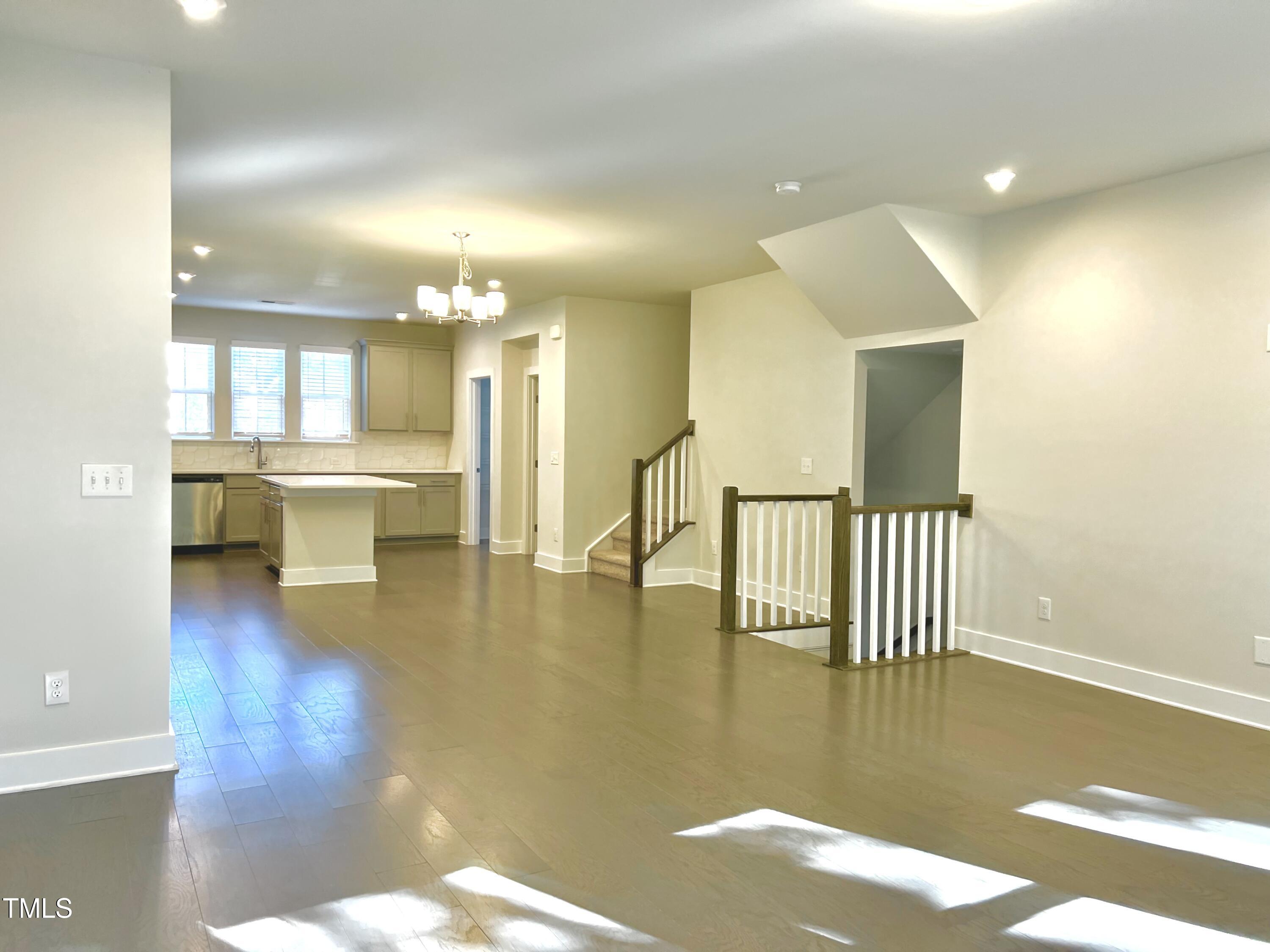 906 Waterside View Drive Raleigh, NC 27606 - Photo 8 of 27 a view of kitchen and dining room with wooden floor