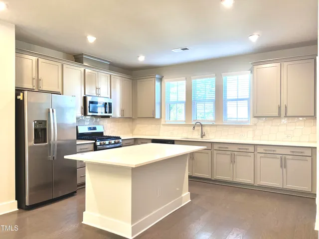 a kitchen with a sink and large window