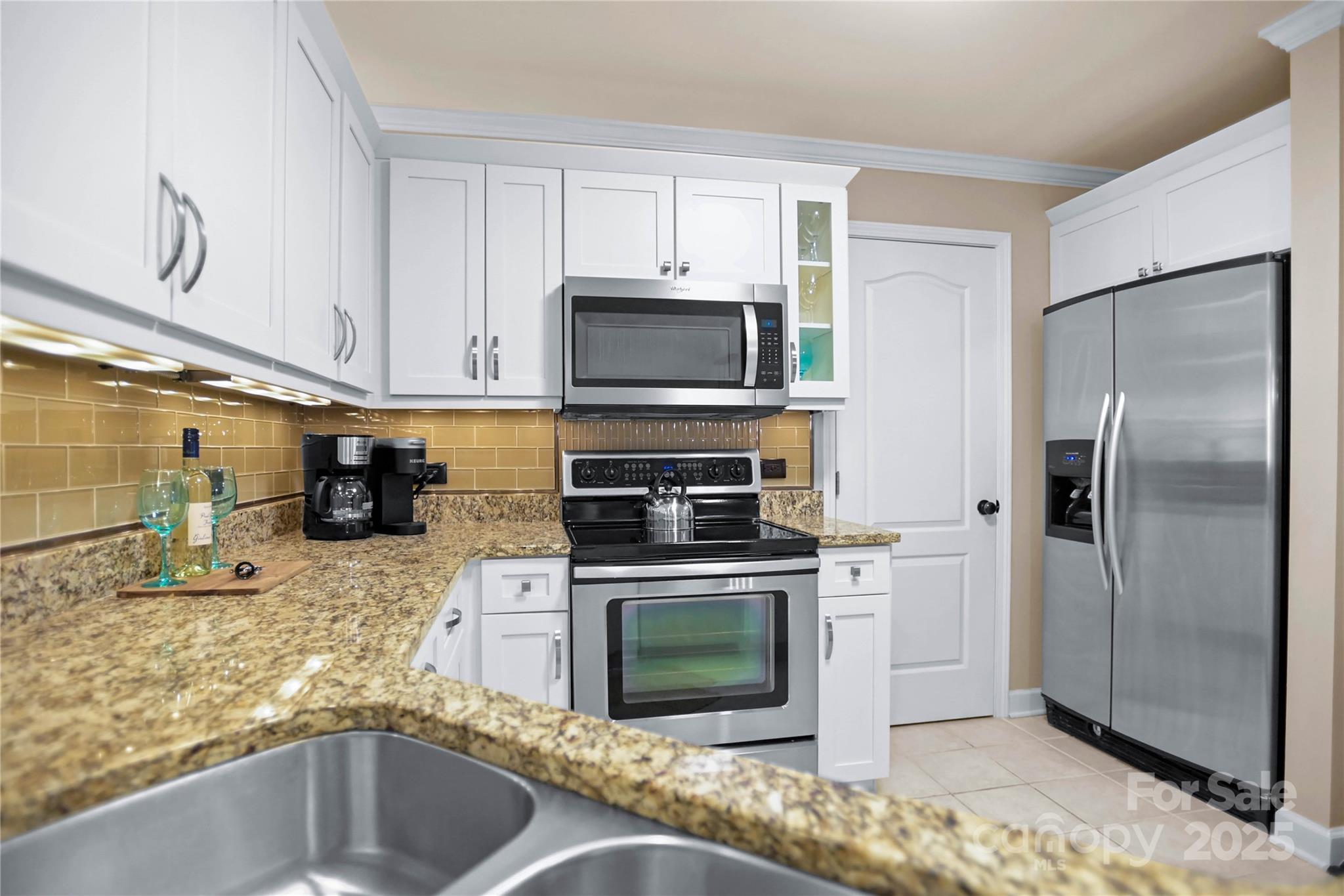 18525 Harborside Drive Cornelius, NC 28031 - Photo 11 of 32 a kitchen with granite countertop a refrigerator stove and microwave