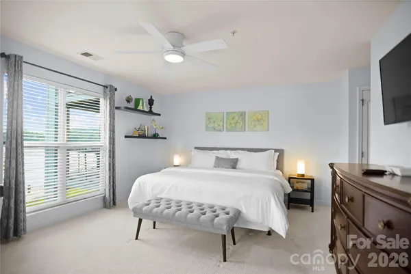 a bedroom with a large bed and a large window