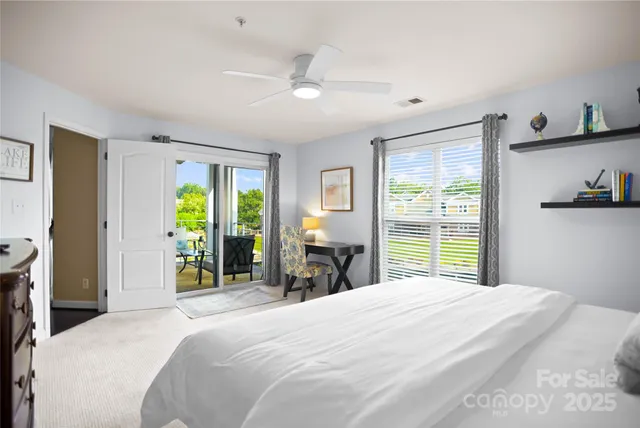 a bedroom with a large bed and a large window