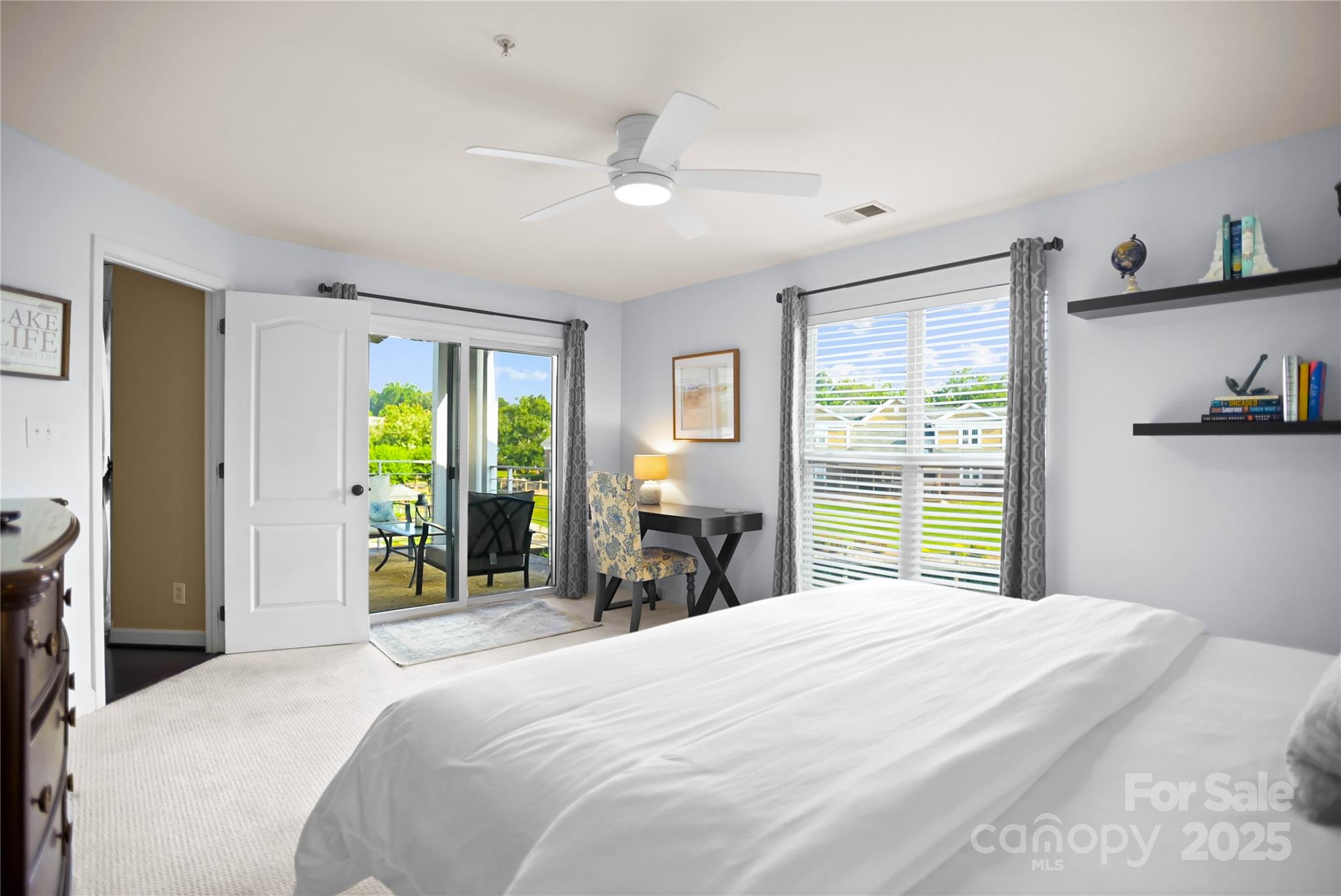 18525 Harborside Drive Cornelius, NC 28031 - Photo 16 of 32 a bedroom with a large bed and a large window