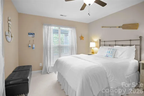 a view of a balcony with furniture and floor to ceiling window