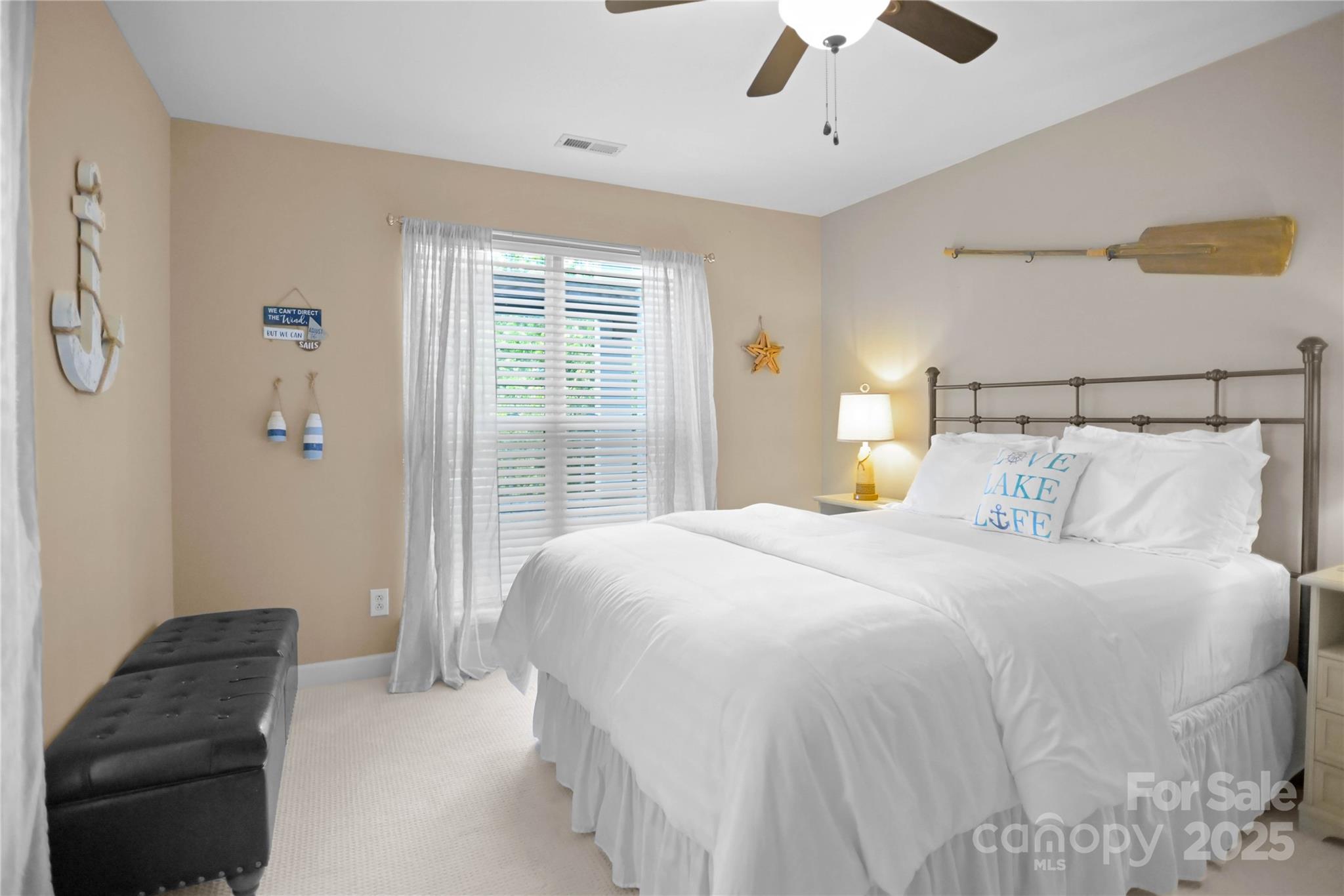 18525 Harborside Drive Cornelius, NC 28031 - Photo 21 of 32 a bedroom with a bed and a chandelier