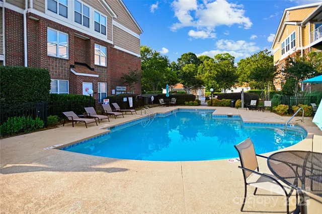 a swimming pool with outdoor seating and yard