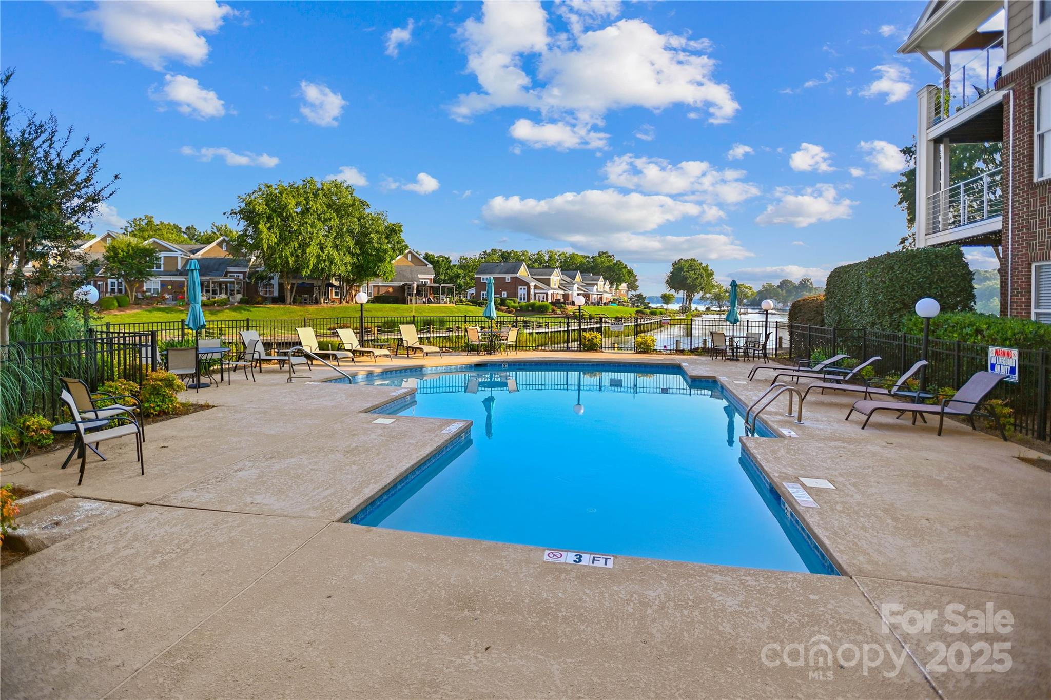 18525 Harborside Drive Cornelius, NC 28031 - Photo 28 of 32 a view of a swimming pool with a lounge chairs