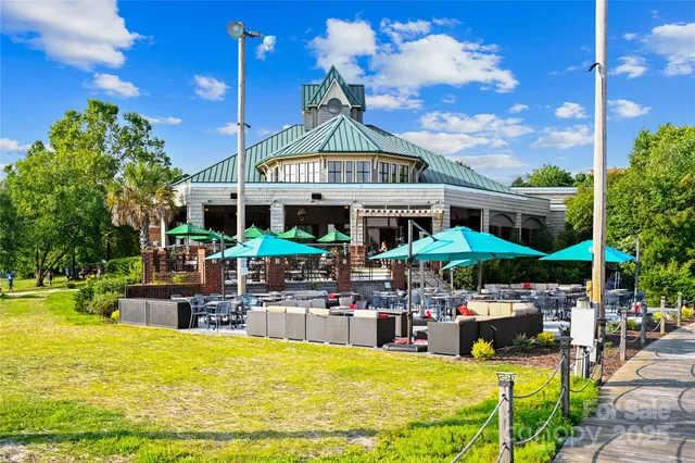 a view of a swimming pool with chairs in patio