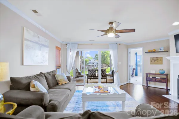 a living room with furniture fireplace and flat screen tv