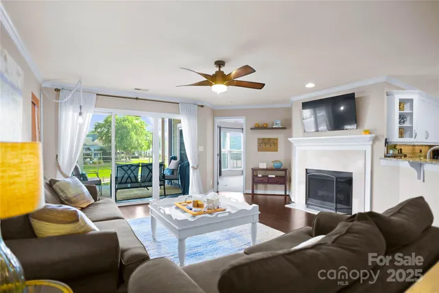 a living room with furniture fireplace and flat screen tv