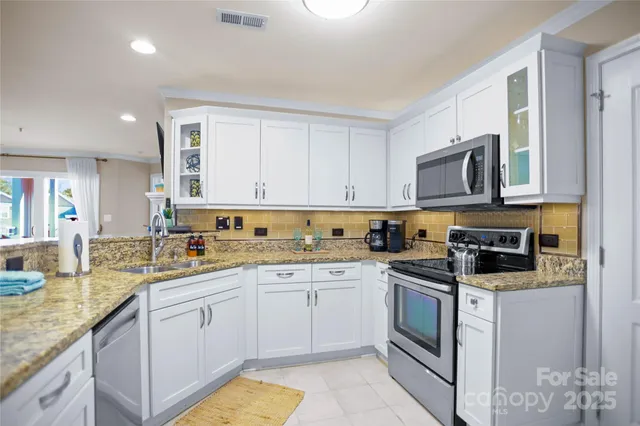 a kitchen with a sink stove and cabinets