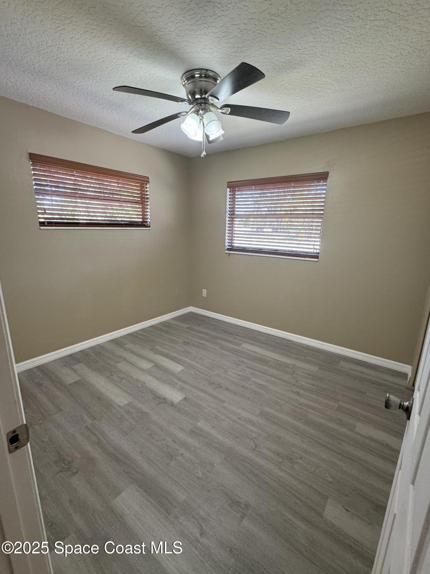 997 Beacon Road Rockledge, FL 32955 - Photo 11 of 18 a view of a room with wooden floor