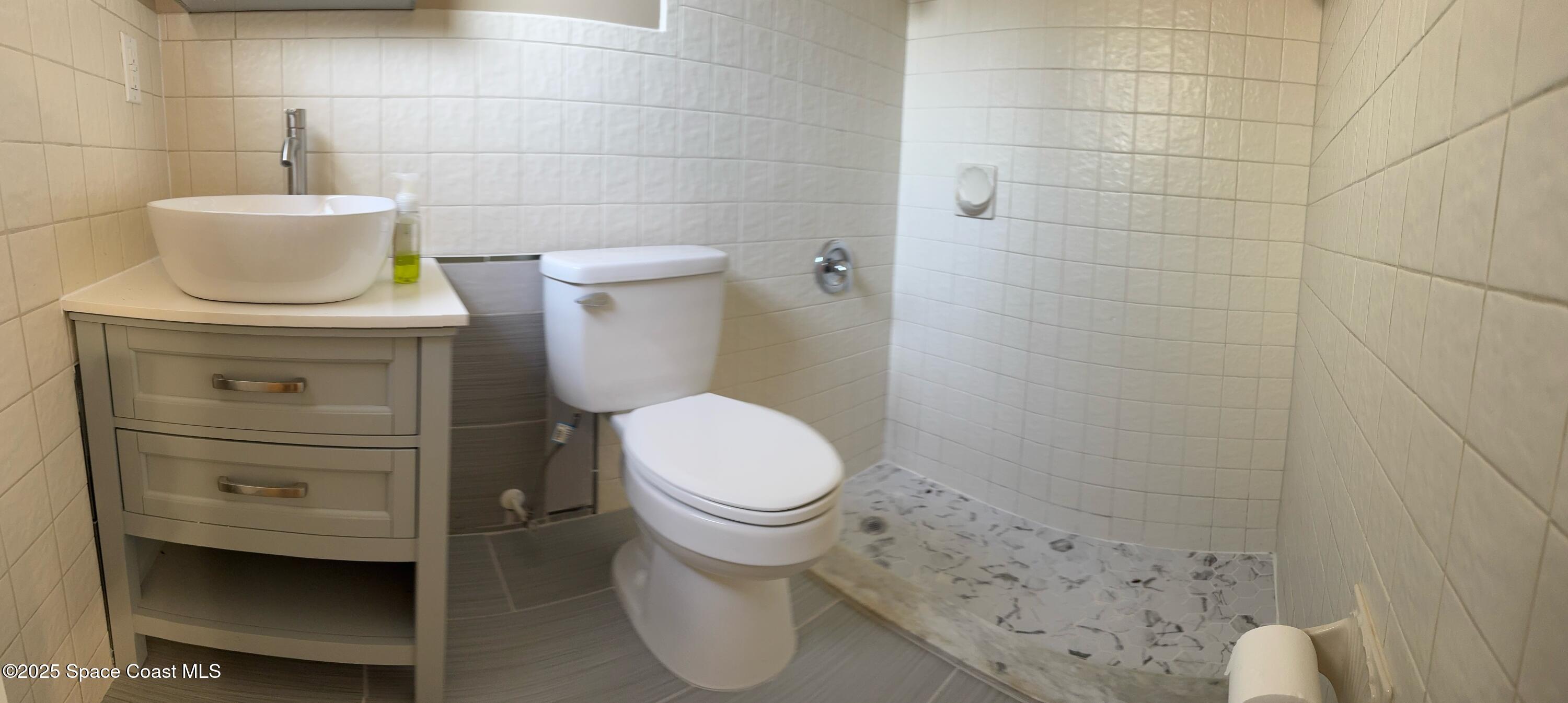 997 Beacon Road Rockledge, FL 32955 - Photo 14 of 18 a bathroom with a toilet and a sink