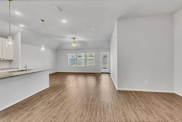 a view of a room with wooden floor and windows