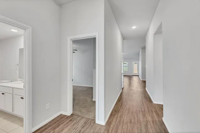 a view of a hallway with wooden floor