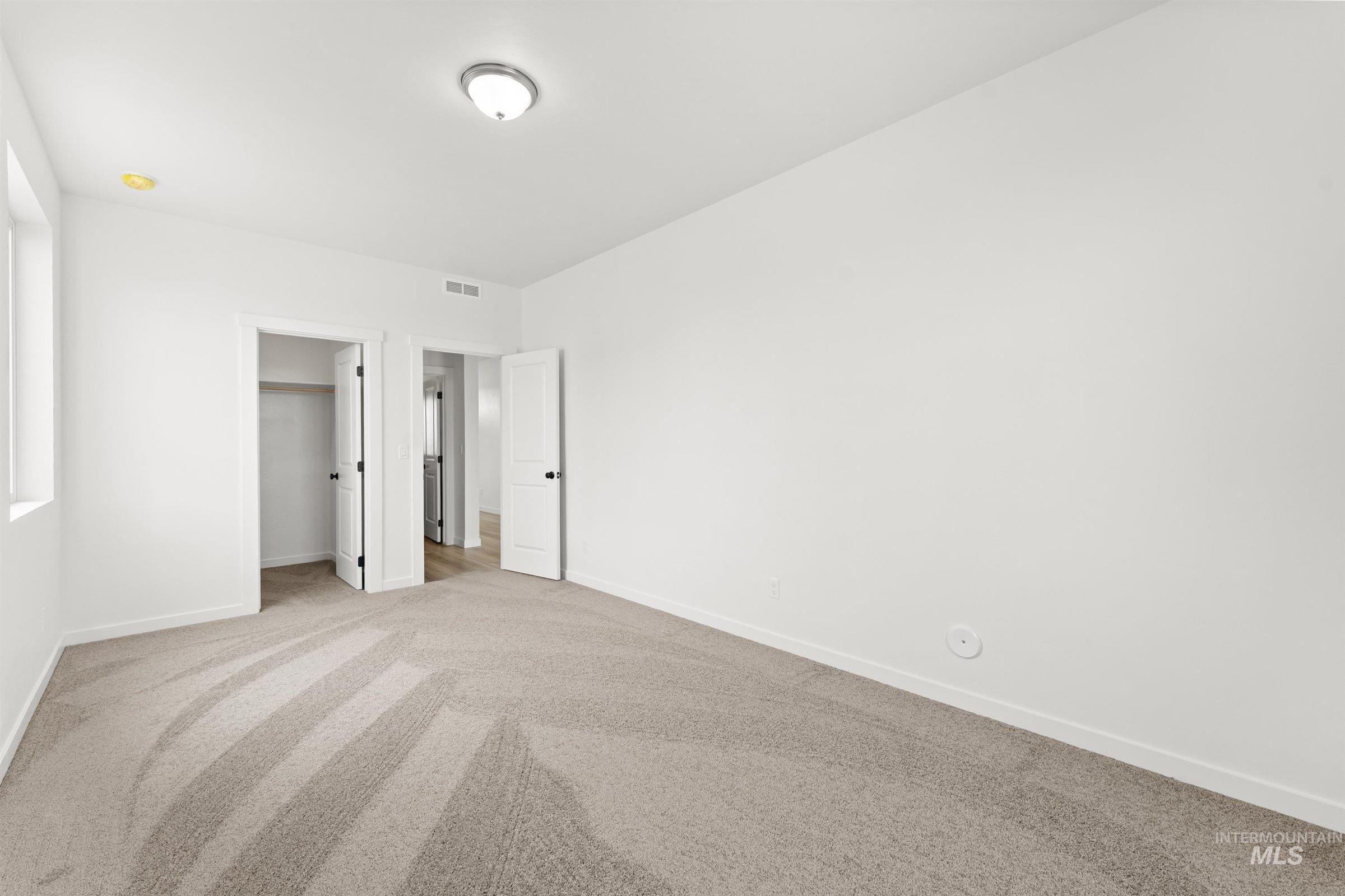 1076 East Exploration Drive Kuna, ID 83634 - Photo 8 of 29 Unfurnished bedroom featuring carpet flooring and baseboards