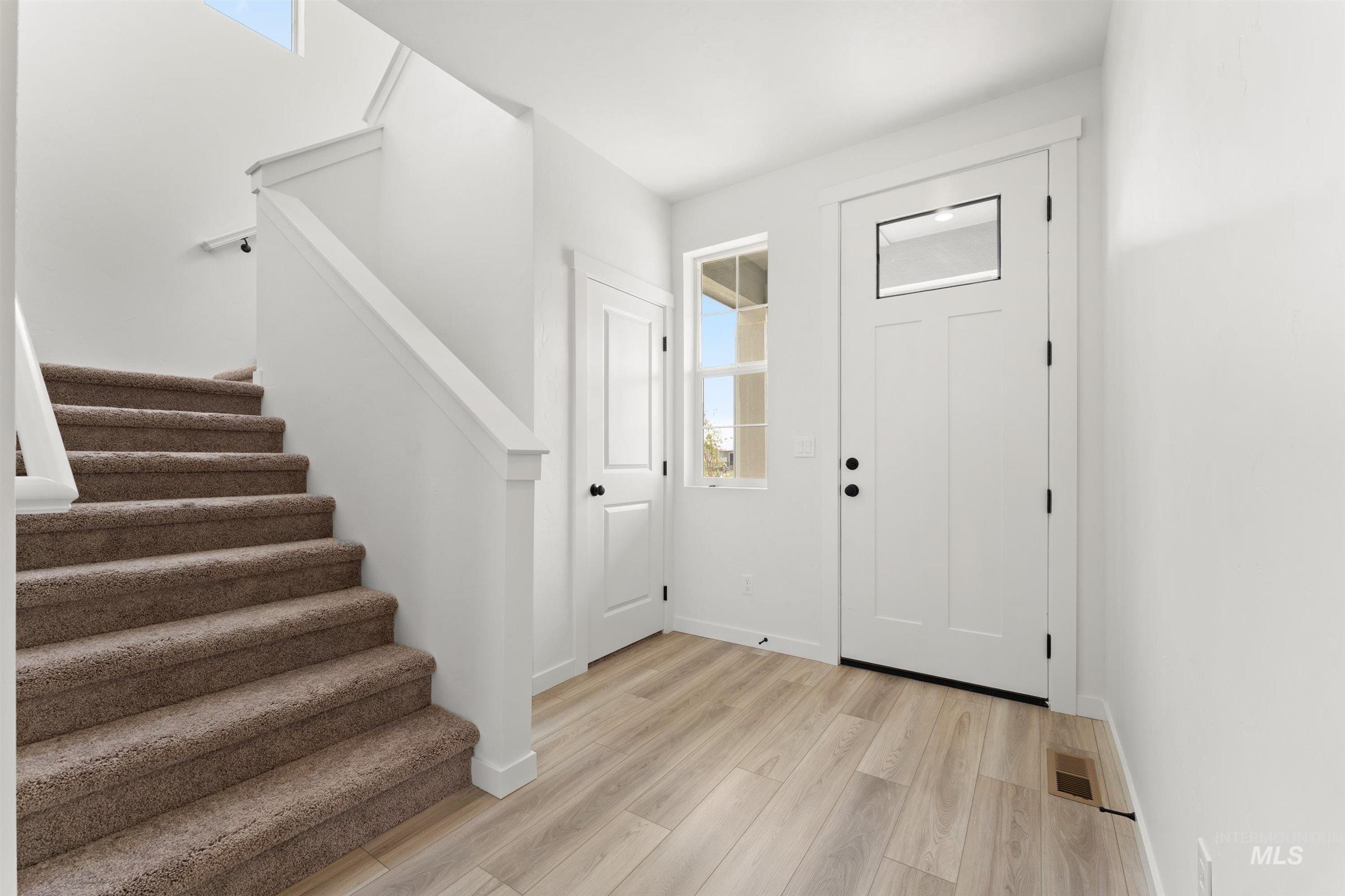 1076 East Exploration Drive Kuna, ID 83634 - Photo 11 of 29 Entrance foyer with stairway and light wood-style flooring