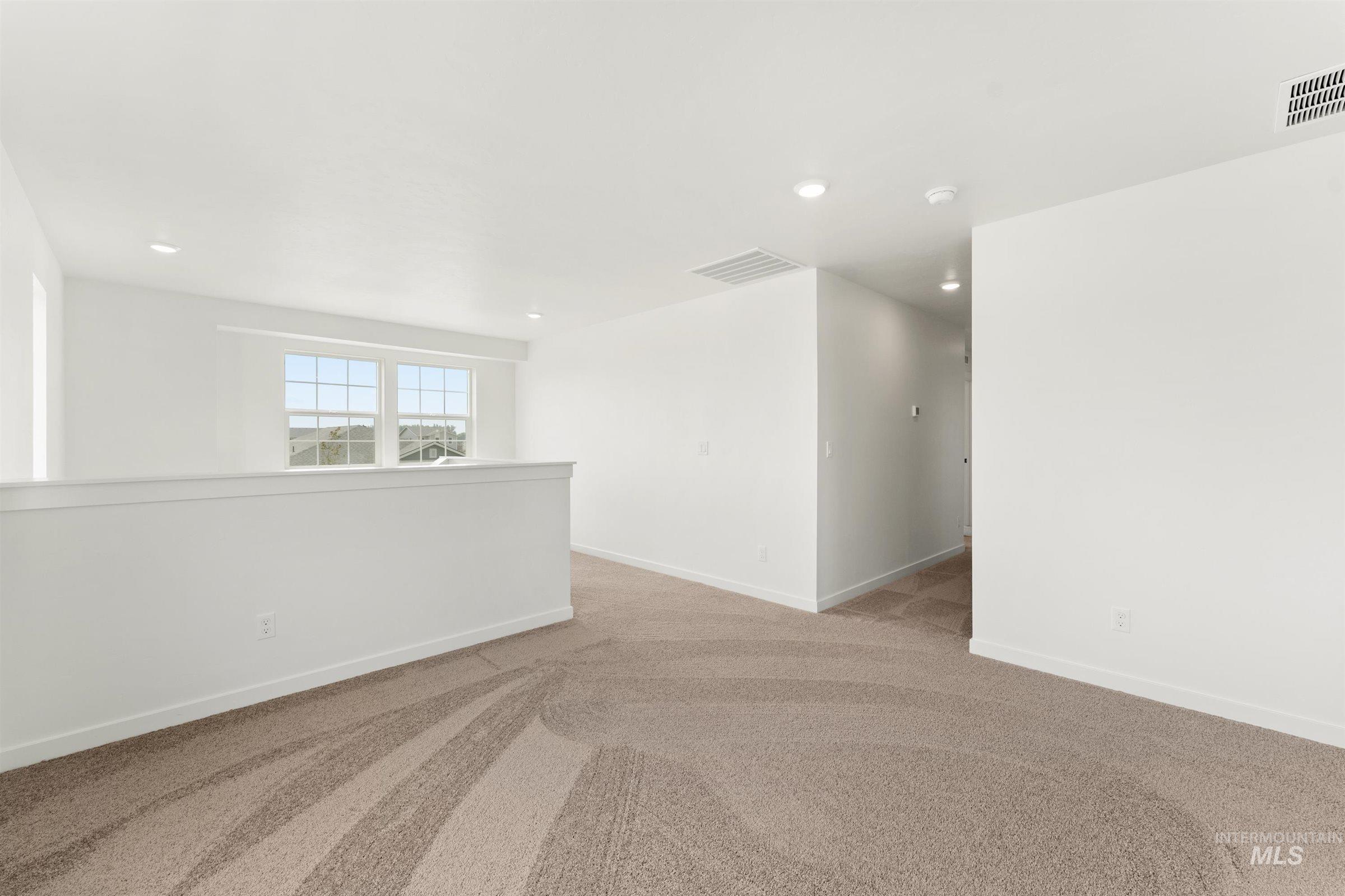 1076 East Exploration Drive Kuna, ID 83634 - Photo 14 of 29 Unfurnished room featuring light carpet and recessed lighting