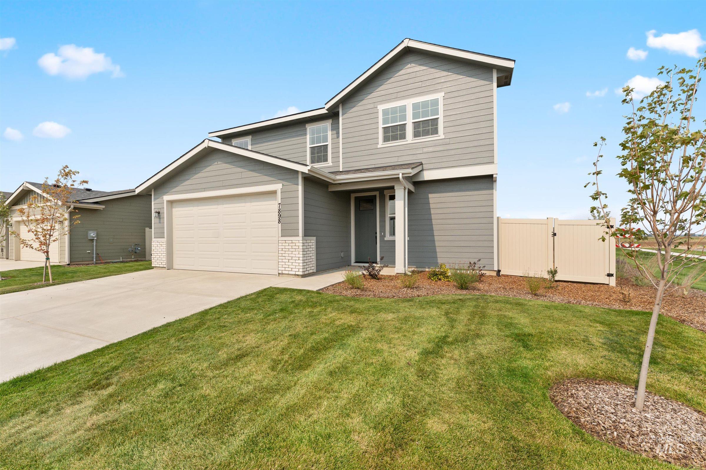 1076 East Exploration Drive Kuna, ID 83634 - Photo 2 of 29 View of front of house with driveway, a garage, and a gate
