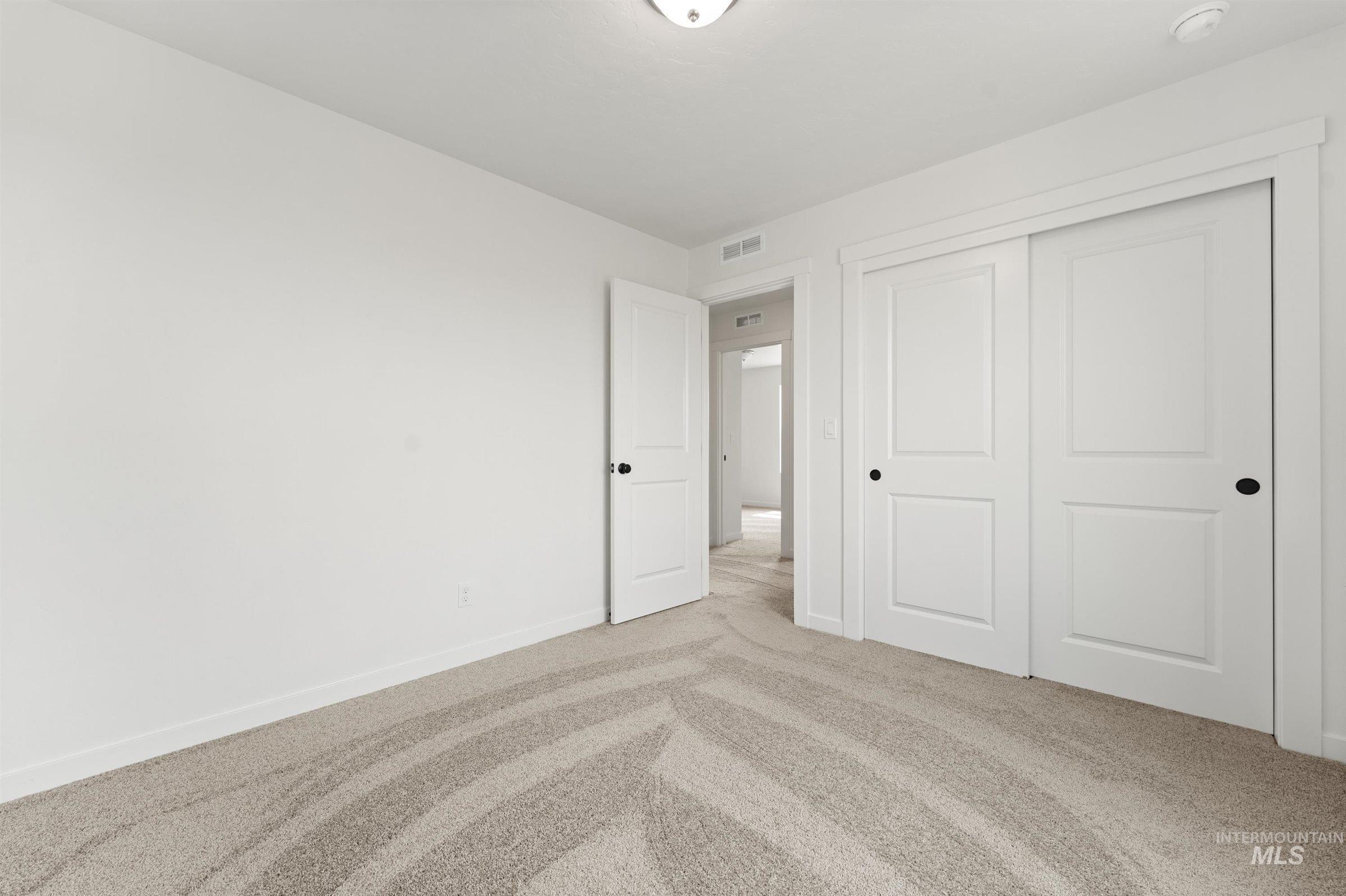 1076 East Exploration Drive Kuna, ID 83634 - Photo 23 of 29 Unfurnished bedroom with carpet and a closet