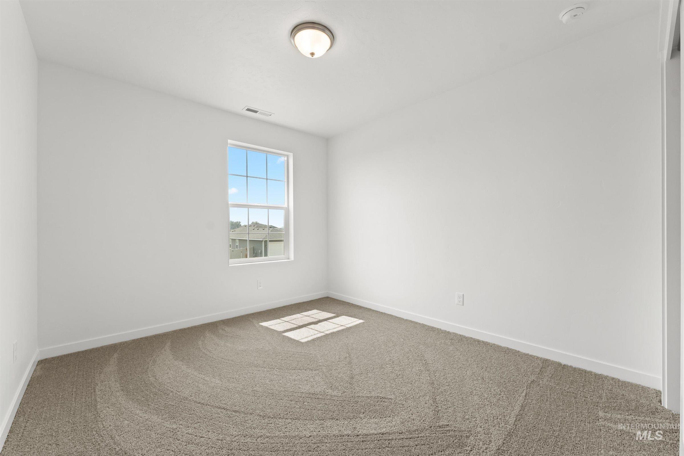 1076 East Exploration Drive Kuna, ID 83634 - Photo 24 of 29 Carpeted empty room featuring baseboards