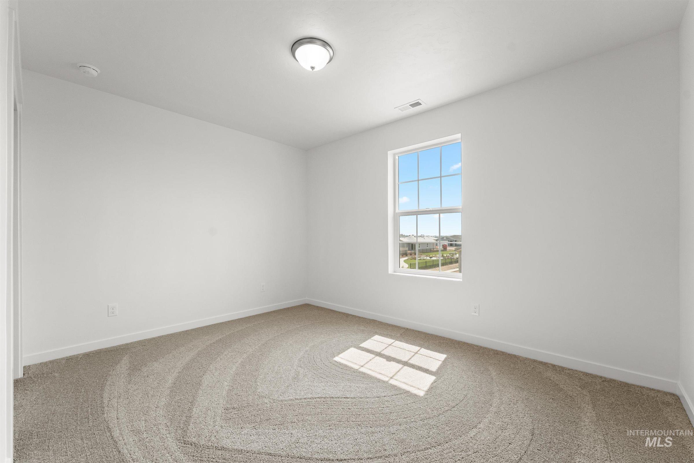 1076 East Exploration Drive Kuna, ID 83634 - Photo 26 of 29 Unfurnished room with light carpet and baseboards
