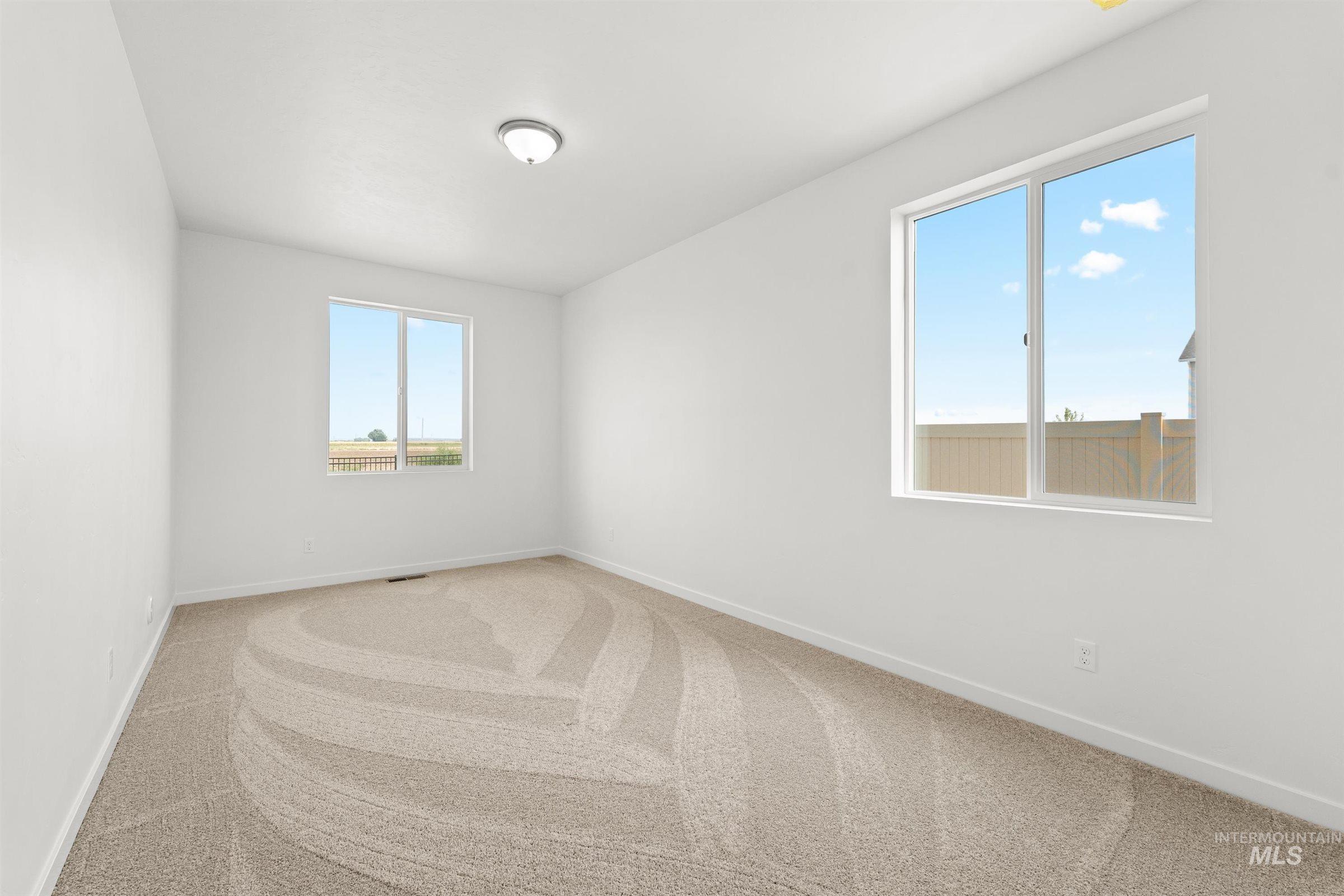 1076 East Exploration Drive Kuna, ID 83634 - Photo 7 of 29 Carpeted spare room with baseboards