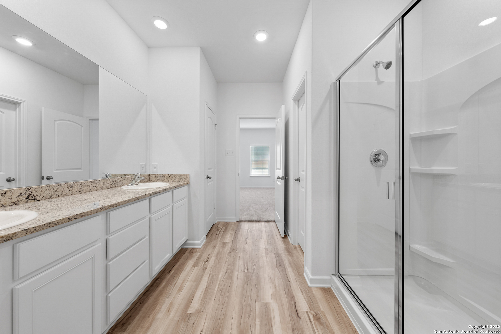 16036 Stratford Cove Lytle, TX 78052 - Photo 12 of 28 a bathroom with a granite countertop sink a toilet and shower