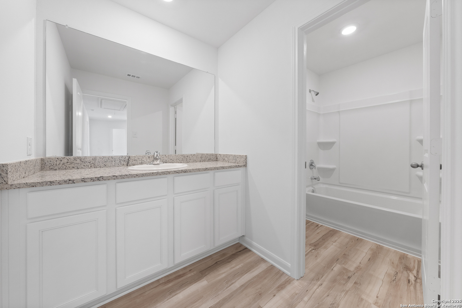16036 Stratford Cove Lytle, TX 78052 - Photo 15 of 28 a bathroom with a granite countertop sink and a mirror