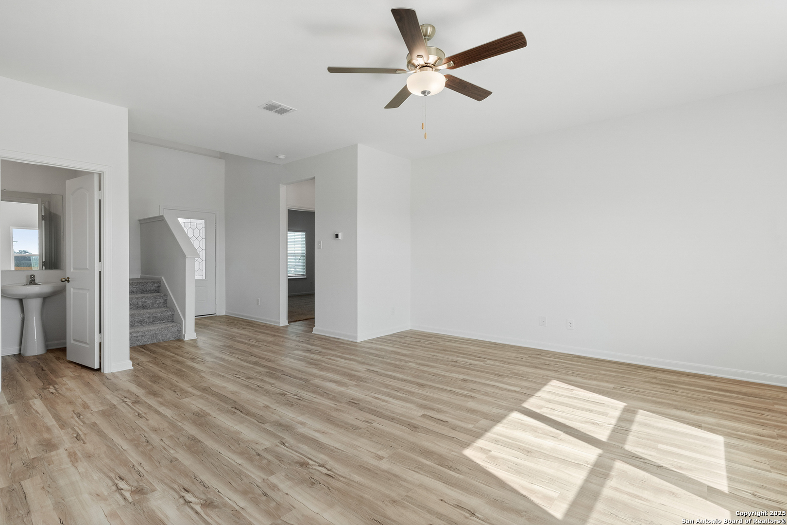 16036 Stratford Cove Lytle, TX 78052 - Photo 7 of 28 a view of empty room with wooden floor and fan
