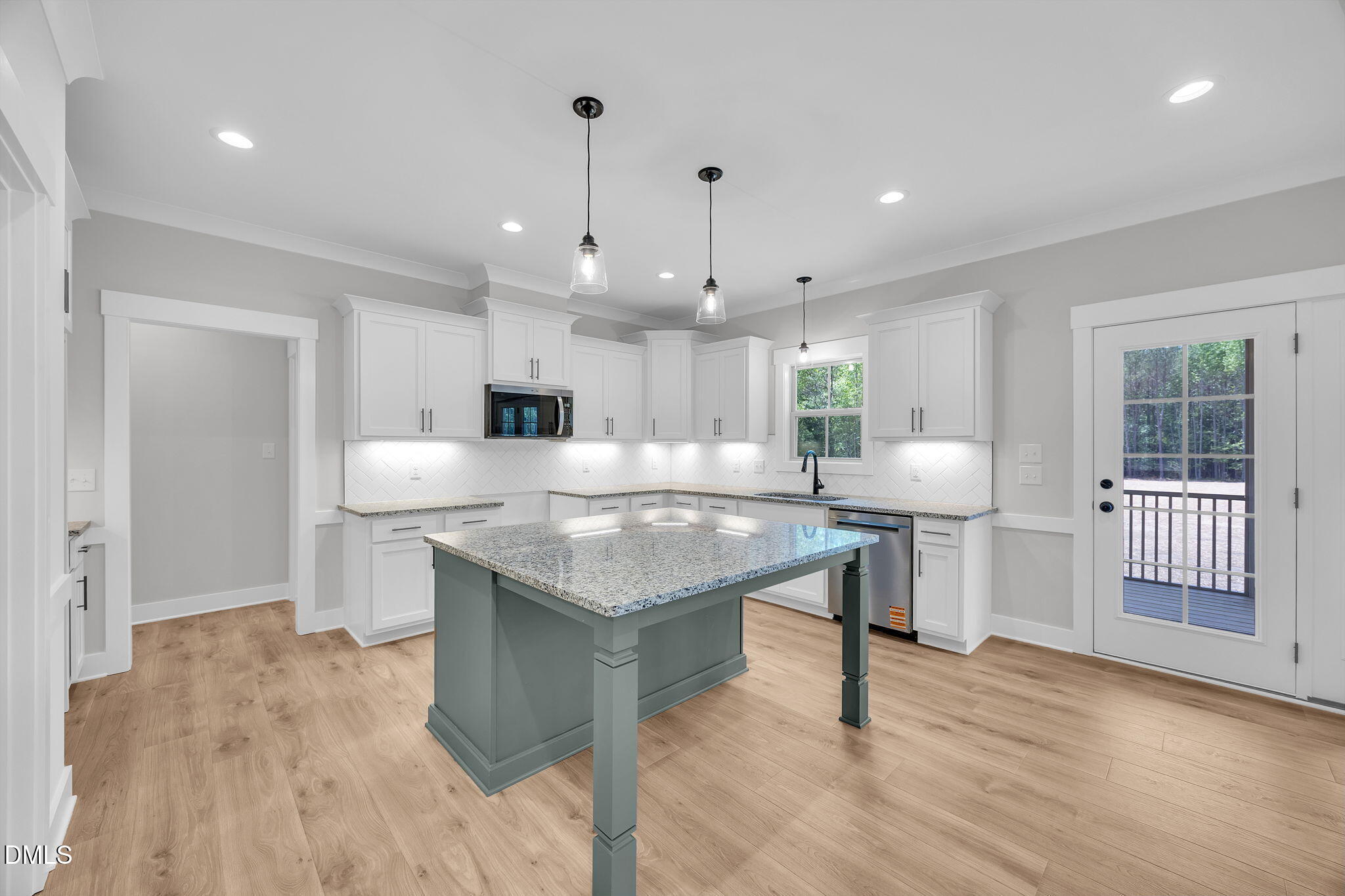 378 Freedom Ridge Drive Smithfield, NC 27577 - Photo 13 of 33 a kitchen with a sink chandelier and a refrigerator