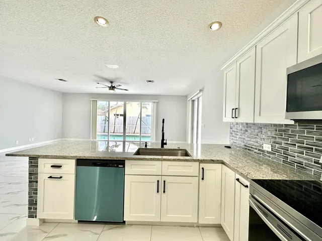 a large bathroom with a granite countertop sink a large mirror and shower