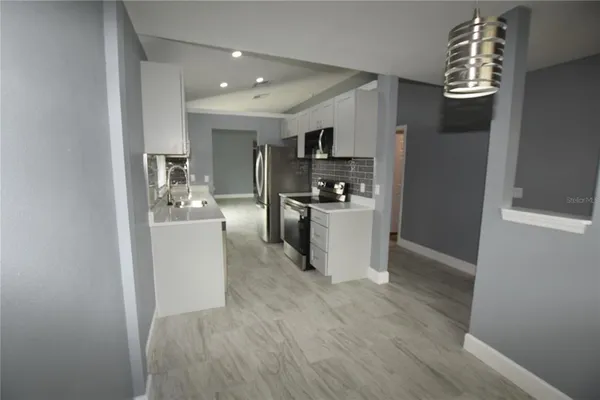 a view of a kitchen with microwave and cabinets