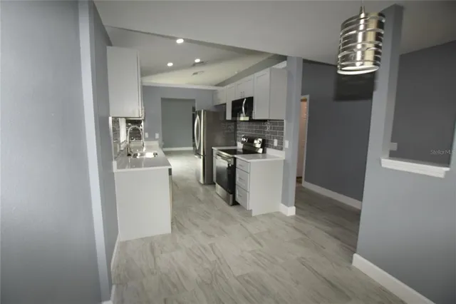 a view of a kitchen with microwave and cabinets