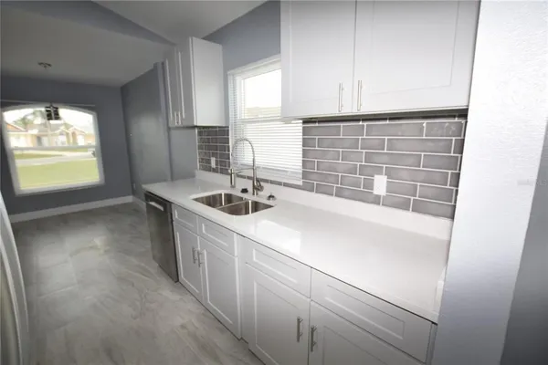 a kitchen with a sink and a window