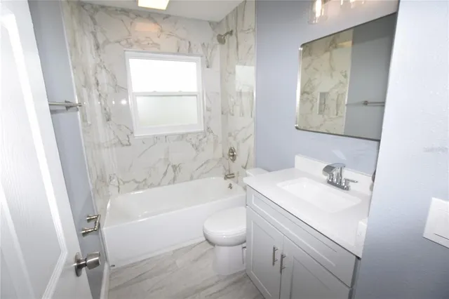 a bathroom with a sink toilet and bathtub