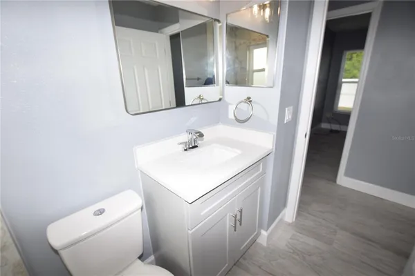 a bathroom with a sink toilet and mirror