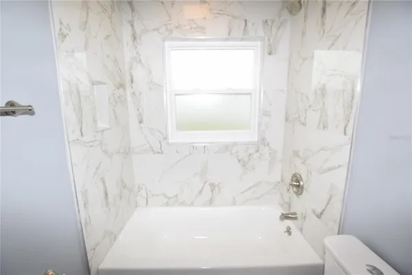 a bathroom with a bathtub and shower