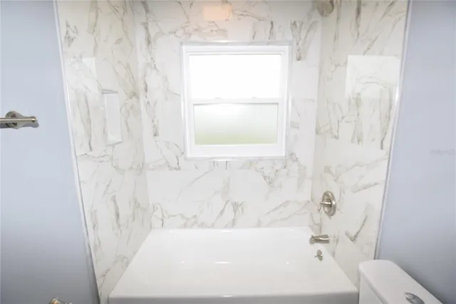 a bathroom with a bathtub and shower