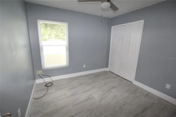 an empty room with a door and a window