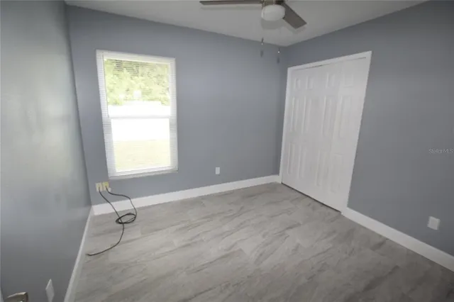 an empty room with a door and a window