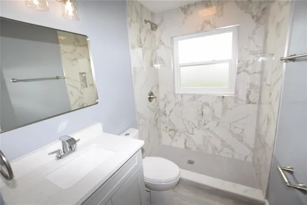 a bathroom with a sink toilet and shower