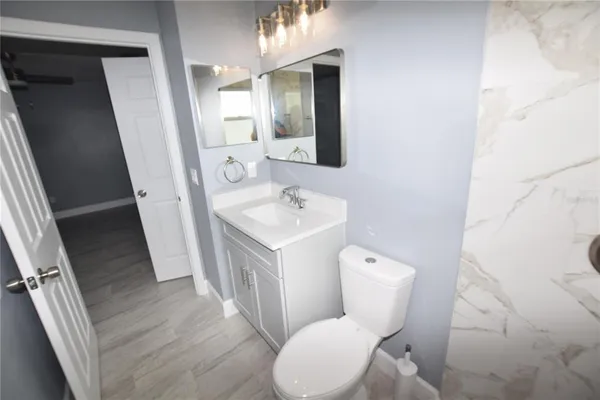 a white toilet sitting next to a bathroom sink