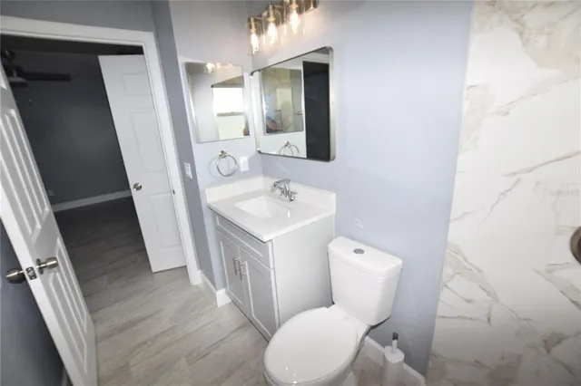 a white toilet sitting next to a bathroom sink