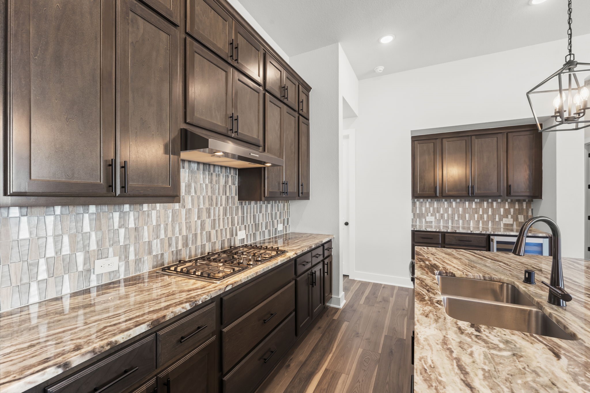 17151 Sandstone Street Conroe, TX 77302 - Photo 15 of 38 a kitchen with stainless steel appliances granite countertop a stove sink and cabinets