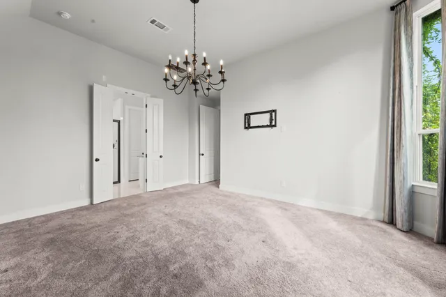 a view of a chandelier in big room and chandelier