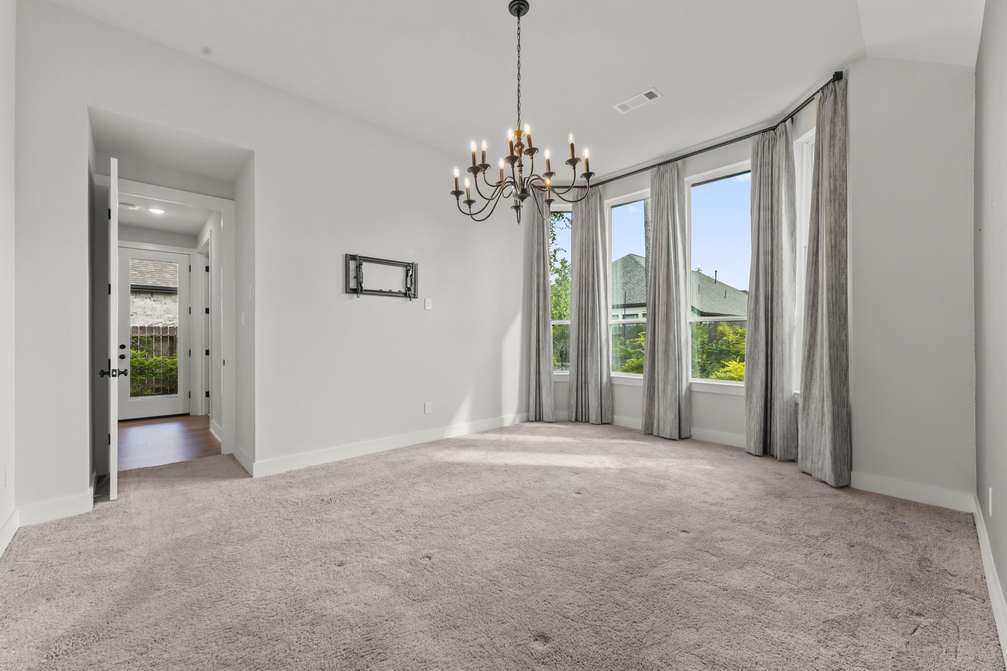 17151 Sandstone Street Conroe, TX 77302 - Photo 20 of 38 a view of a livingroom with a chandelier fan and windows