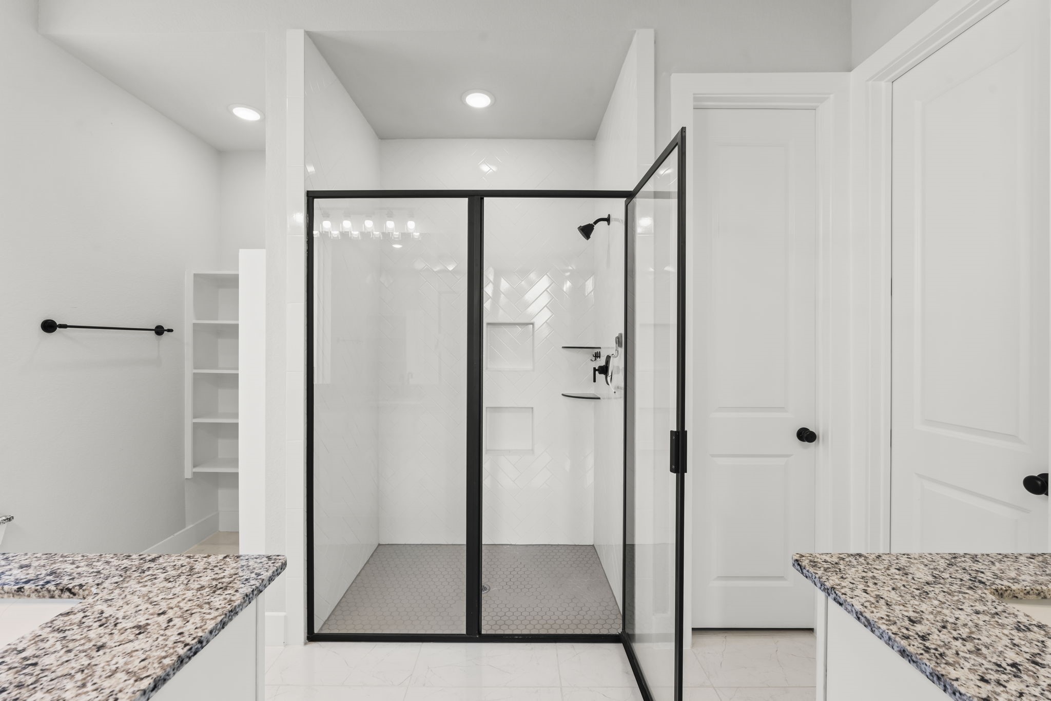 17151 Sandstone Street Conroe, TX 77302 - Photo 21 of 38 a bathroom with a granite countertop sink a mirror and shower