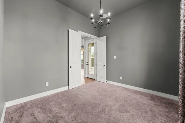 a view of a chandelier in big room and a chandelier fan