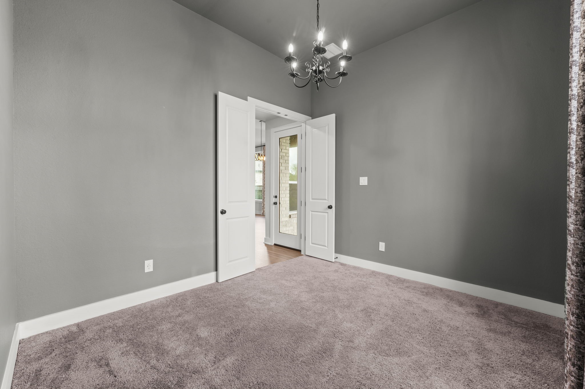 17151 Sandstone Street Conroe, TX 77302 - Photo 26 of 38 a view of a chandelier in big room and a chandelier fan